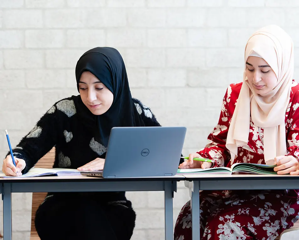 Twee personen aan het schrijven.